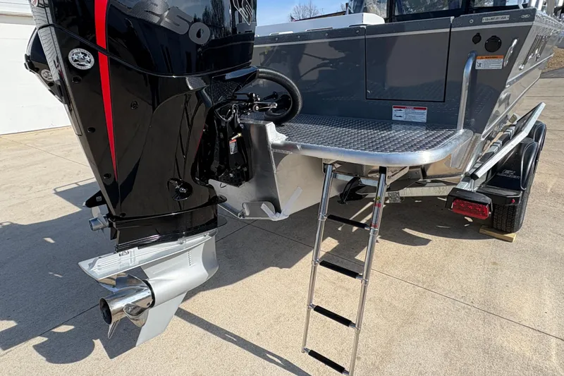 Slide: The Image of 2026 Lund 210 Heavy Gauge boat with outboard motor and rear ladder. - 9