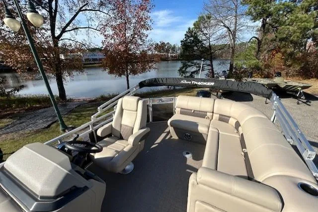 Slide: The Image of 2025 Sun Tracker Party Barge 20 DLX pontoon boat on a scenic lake. - 4