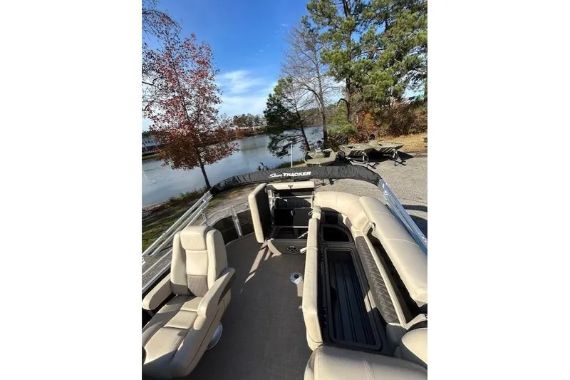 Slide: The Image of 2025 Sun Tracker Party Barge 20 DLX pontoon boat by a scenic lake. - 5
