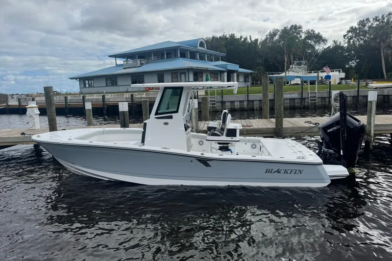 The Image of 2026 Blackfin 262 HB boat docked by a marina under cloudy skies. - 10