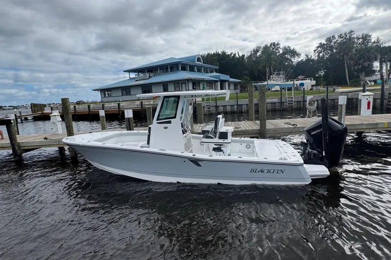 Slide: The Image of 2026 Blackfin 262 HB boat docked at a marina under cloudy skies. - 40