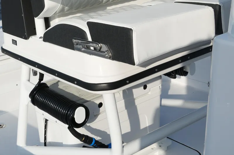 Slide: The Image of 2026 Blackfin 262 HB boat seat with storage and coiled hose underneath. - 47