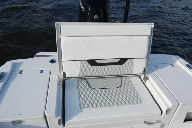 Slide: The Image of 2026 Blackfin 262 HB boat with open storage compartment, white cushioned seating, and diamond pattern design. - 48