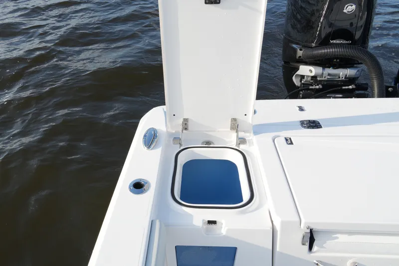 Slide: The Image of 2026 Blackfin 262 HB boat with open hatch and visible engine on water. - 50
