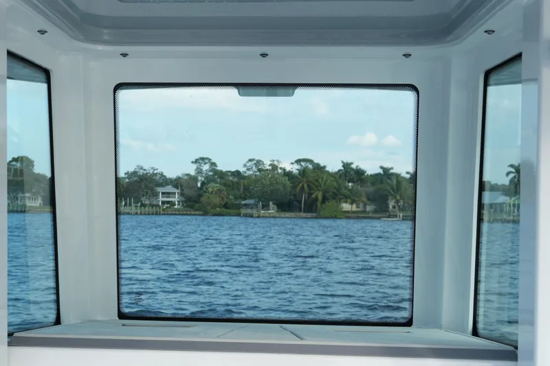 Slide: The Image of View from inside a 2026 Blackfin 262 HB boat, overlooking a serene waterfront scene. - 57