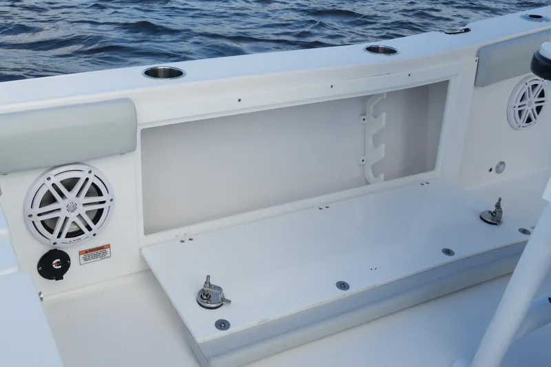 Slide: The Image of 2026 Blackfin 262 HB boat interior with storage compartment and speaker, on water. - 64