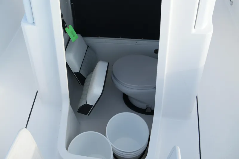 Slide: The Image of Interior of 2026 Blackfin 262 HB boat featuring a compact marine toilet. - 69