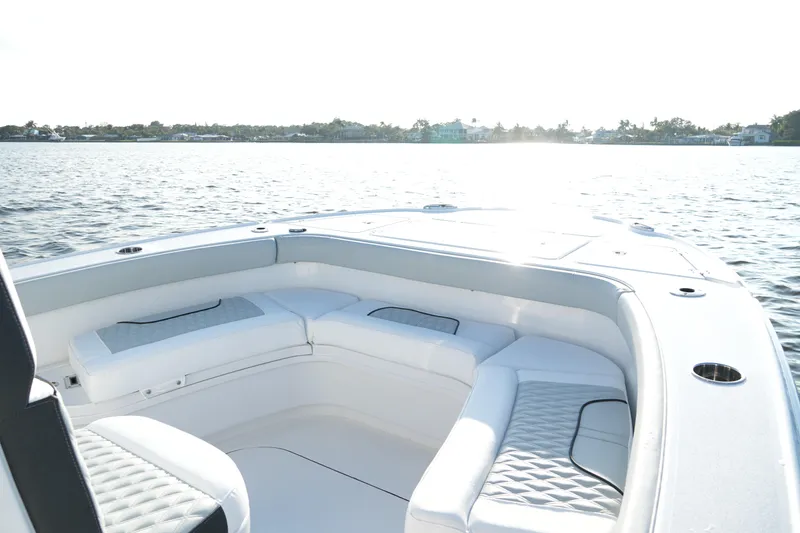 Slide: The Image of 2026 Blackfin 262 HB boat interior with white seating on calm water. - 74