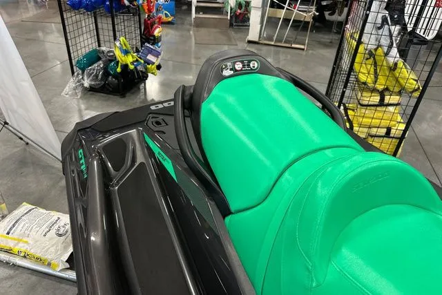 Slide: The Image of 2026 Sea-Doo GTI jet ski with green seat in showroom. - 27
