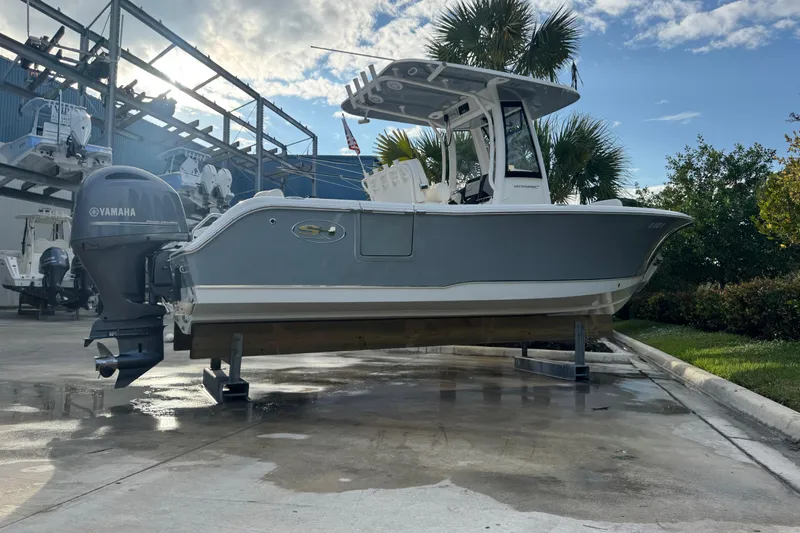 Slide: The Image of 2019 Sea Hunt Ultra 235 SE boat with Yamaha engine on display outdoors. - 11