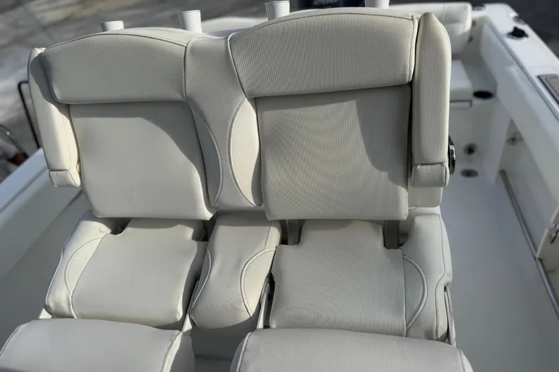 Slide: The Image of 2019 Sea Hunt Ultra 235 SE boat seats, featuring plush white upholstery. - 13