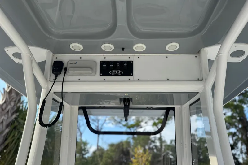 Slide: The Image of 2019 Sea Hunt Ultra 235 SE boat console with Garmin equipment and controls. - 22