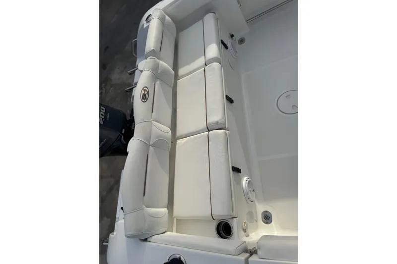 Slide: The Image of 2019 Sea Hunt Ultra 235 SE boat interior with white cushioned seating. - 26