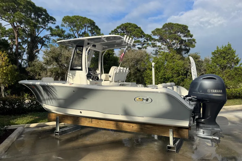 Slide: The Image of 2019 Sea Hunt Ultra 235 SE boat with Yamaha engine, parked outdoors. - 27