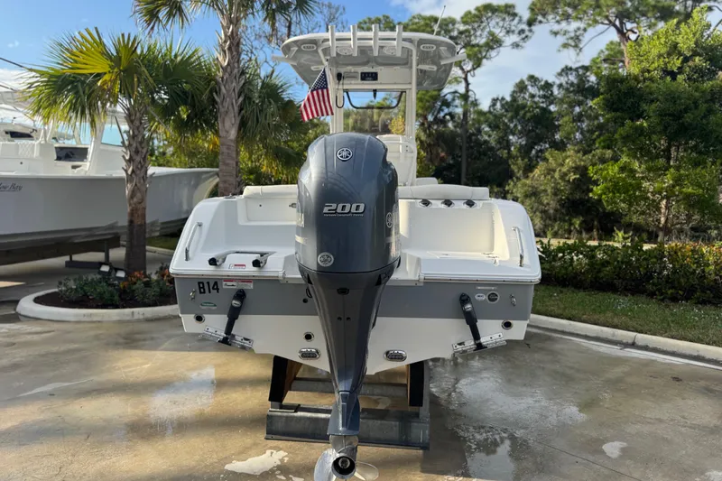 Slide: The Image of 2019 Sea Hunt Ultra 235 SE boat with Yamaha 200 engine, parked outdoors. - 28