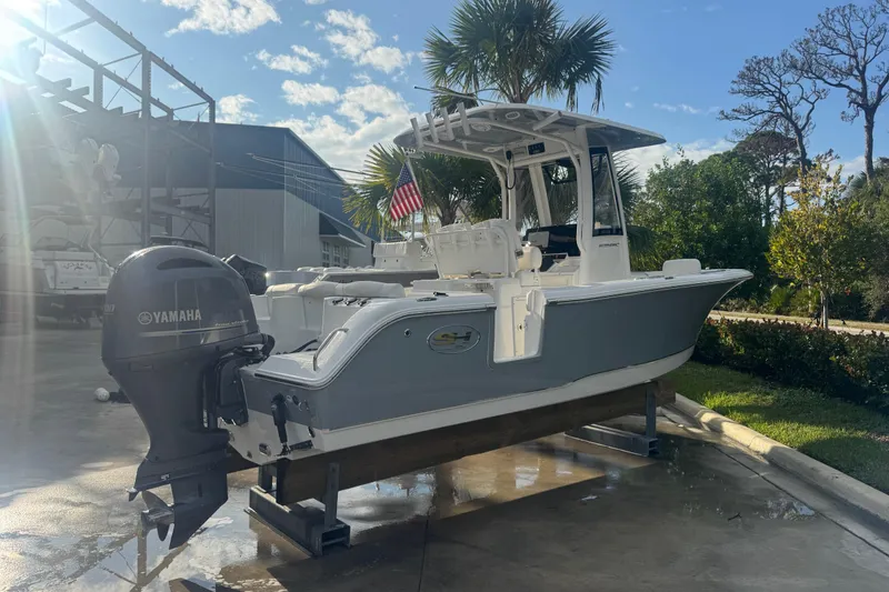 Slide: The Image of 2019 Sea Hunt Ultra 235 SE boat with Yamaha engine on display outdoors. - 29