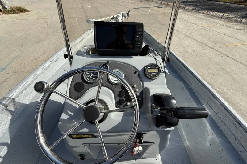 Slide: The Image of 2018 Excel 203 Bay Pro boat console with steering wheel and navigation equipment. - 14