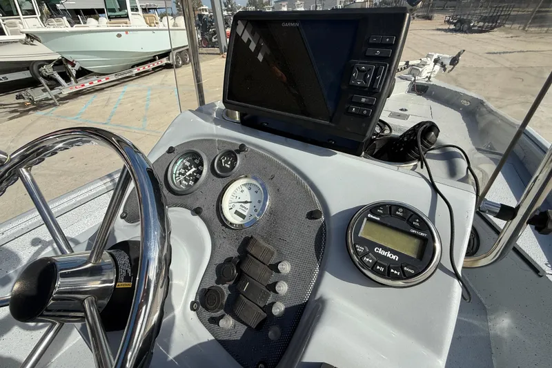 Slide: The Image of 2018 Excel 203 Bay Pro boat dashboard with steering wheel and Garmin display. - 15