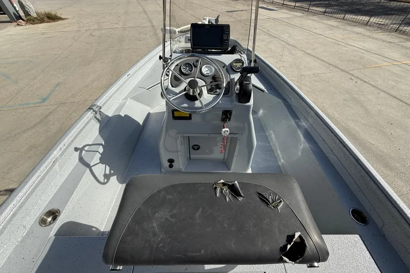 Slide: The Image of 2018 Excel 203 Bay Pro boat interior with damaged seat and steering console. - 9