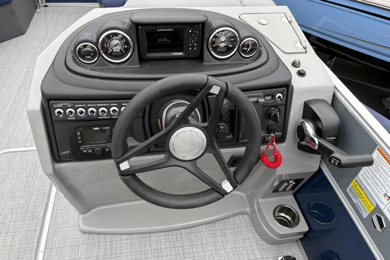 Slide: The Image of 2026 South Bay S 224 boat dashboard with steering wheel and control panel. - 13