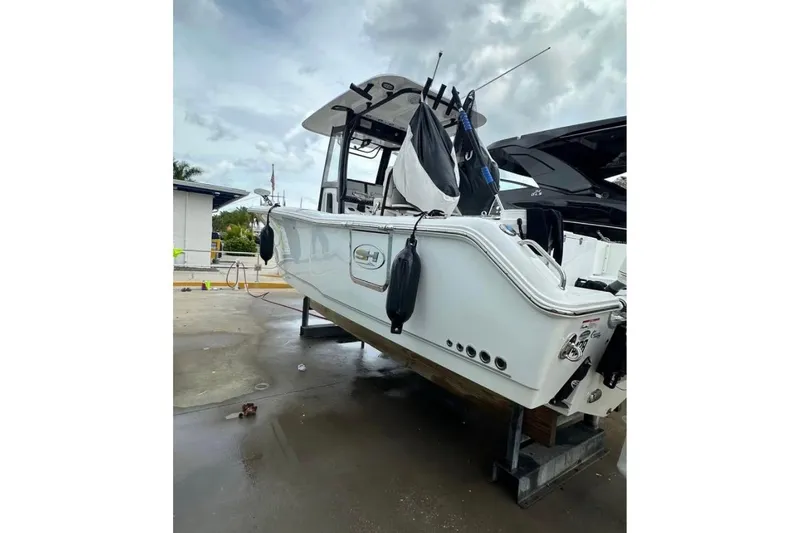 Slide: The Image of 2024 Sea Hunt Gamefish 25 boat on a stand, ready for maintenance. - 3