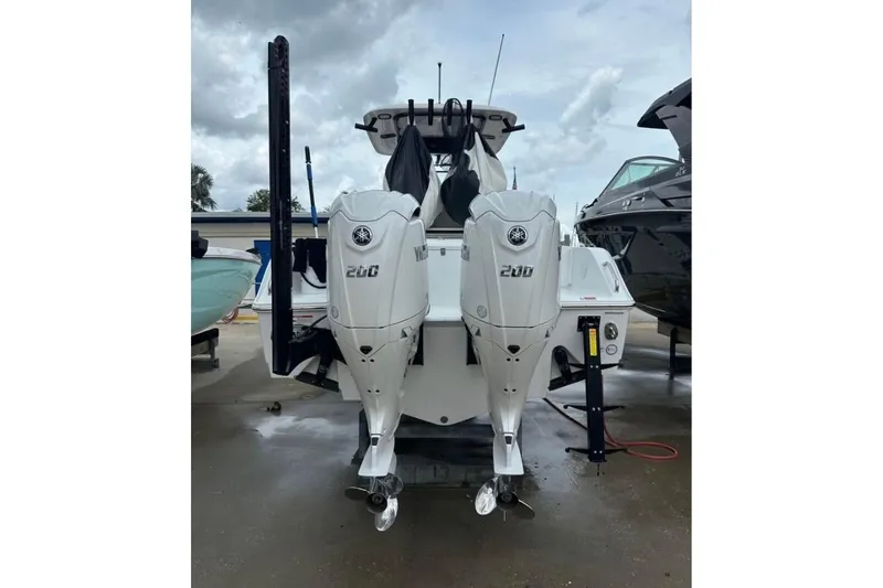 Slide: The Image of 2024 Sea Hunt Gamefish 25 with dual Yamaha 200 engines, docked outdoors. - 4