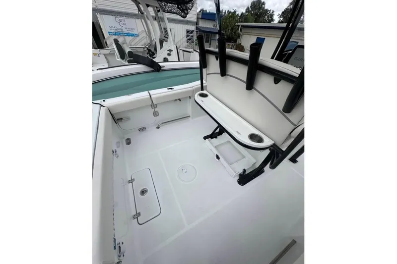 Slide: The Image of 2024 Sea Hunt Gamefish 25 boat interior with rod holders and storage compartments. - 5