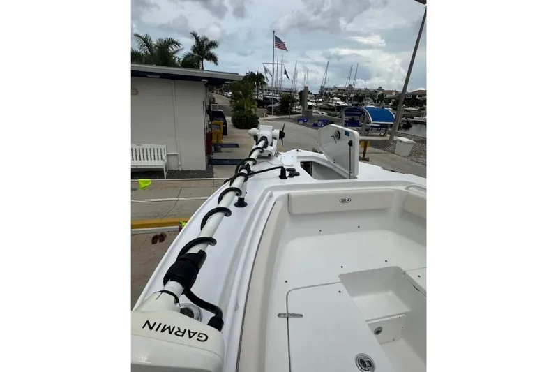 Slide: The Image of 2024 Sea Hunt Gamefish 25 boat docked, featuring Garmin equipment, marina in background. - 8