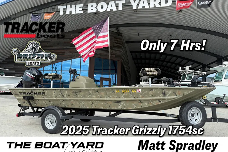 The Image of 2025 Tracker Grizzly 1754 SC boat displayed at The Boat Yard with American flag. - 1