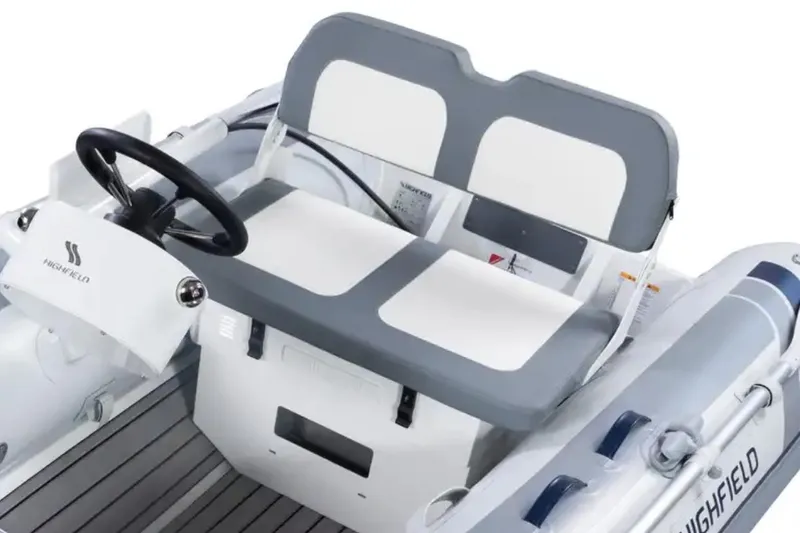 Slide: The Image of Manufacturer Provided Image: 2024 Highfield Classic 340 FCT boat interior with steering wheel and seating. - 3