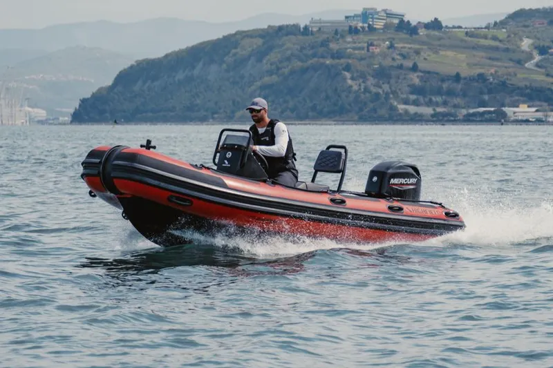 The Image of Manufacturer Provided Image: 2025 Highfield Patrol 460 boat cruising on water with scenic mountain backdrop. - 1