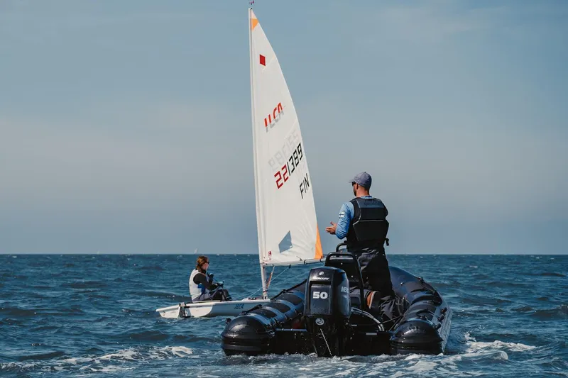 Slide: The Image of Manufacturer Provided Image: Highfield Patrol 460 boat on the sea, 2025 model, with a sailboat nearby. - 3