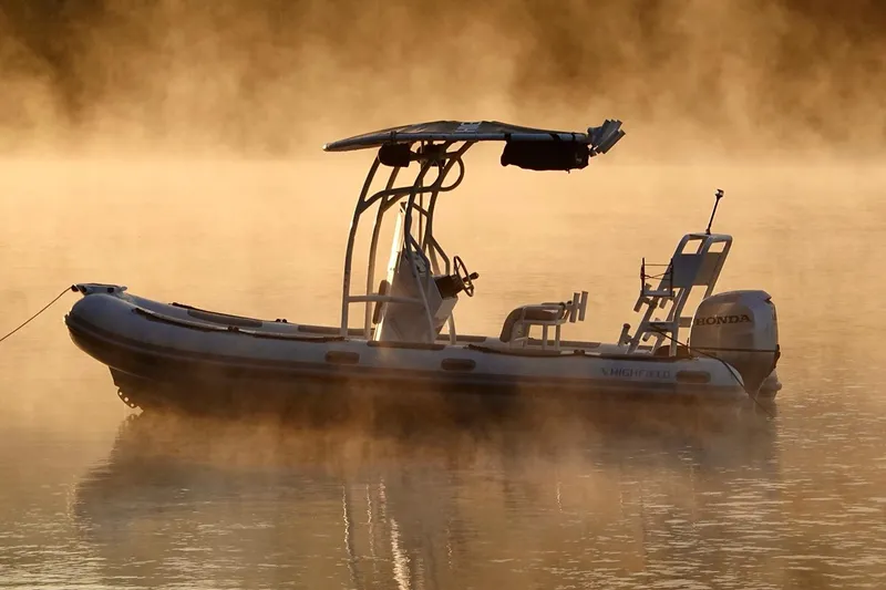 Slide: The Image of Manufacturer Provided Image: Highfield Patrol 540 boat on misty water at sunrise, 2025 model. - 2