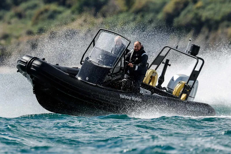 The Image of Manufacturer Provided Image: Highfield Patrol 600 boat speeding on water, 2025 model, with two passengers. - 0