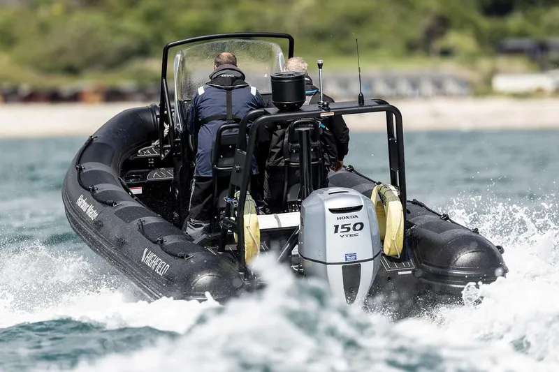 Slide: The Image of Manufacturer Provided Image: 2025 Highfield Patrol 600 boat with Honda 150 engine navigating choppy waters. - 2