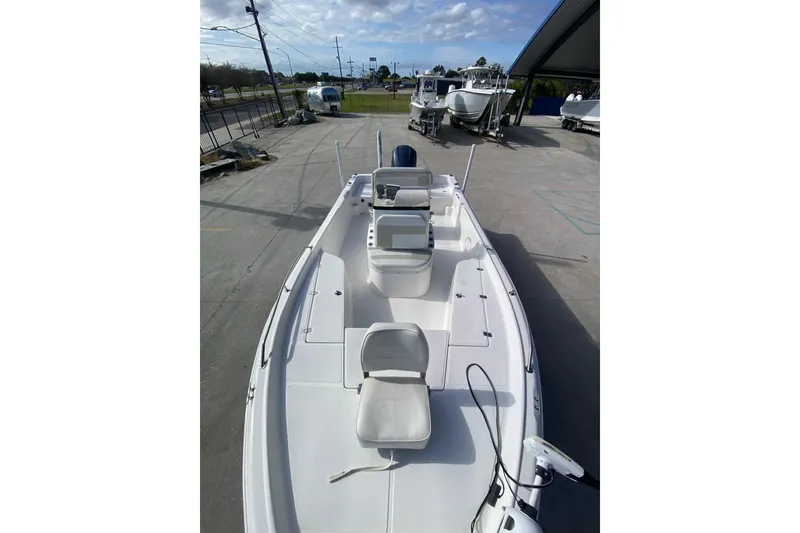 Slide: The Image of 2006 Sea Quest 2100 Probay boat, white interior, docked at marina under blue sky. - 12