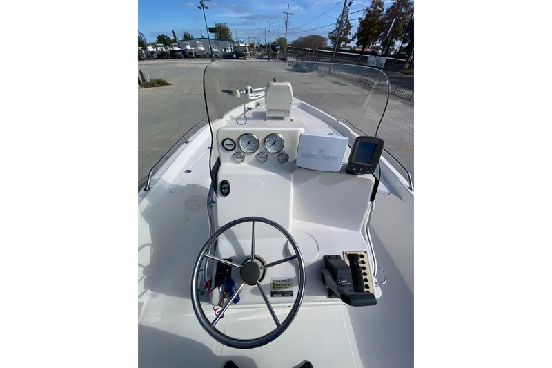 Slide: The Image of 2006 Sea Quest 2100 Probay boat dashboard with steering wheel and navigation equipment. - 18