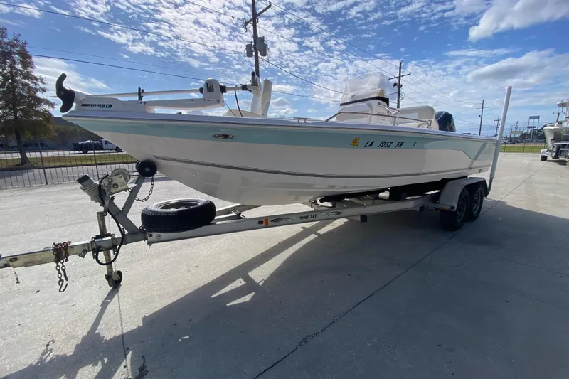 Slide: The Image of 2006 Sea Quest 2100 Probay boat on trailer under a partly cloudy sky. - 7