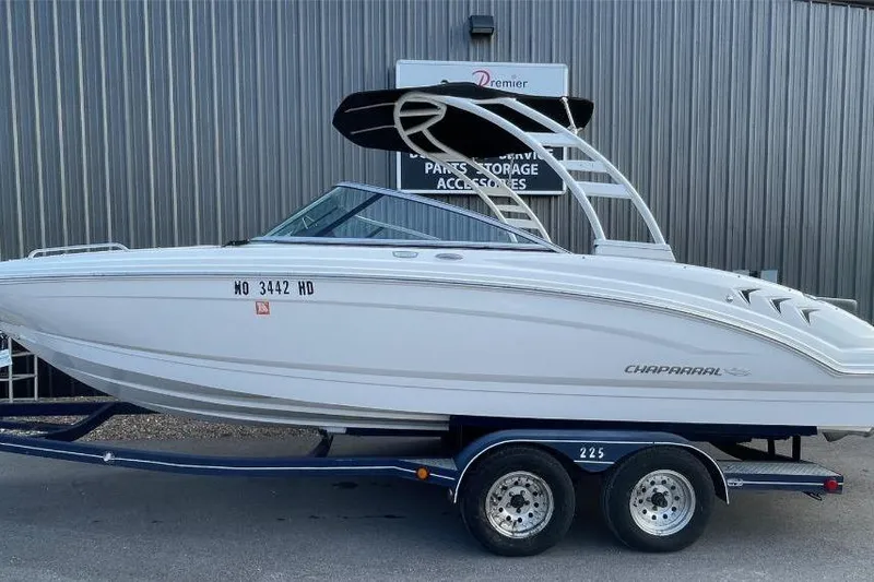 The Image of 2023 Chaparral 23 SSi boat on trailer, parked outside a storage facility. - 0