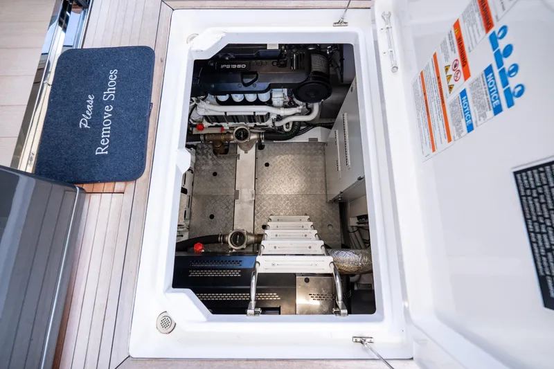 Slide: The Image of Engine room of 2024 Azimut Fly 68 yacht with visible machinery and safety instructions. - 19