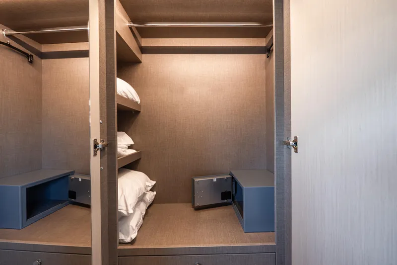 Slide: The Image of Luxurious closet interior on 2024 Azimut Fly 68 yacht, featuring shelves and safes. - 25