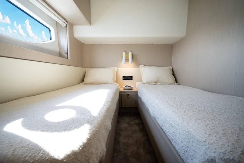Slide: The Image of Interior of 2024 Azimut Fly 68 yacht with twin beds and window view. - 35