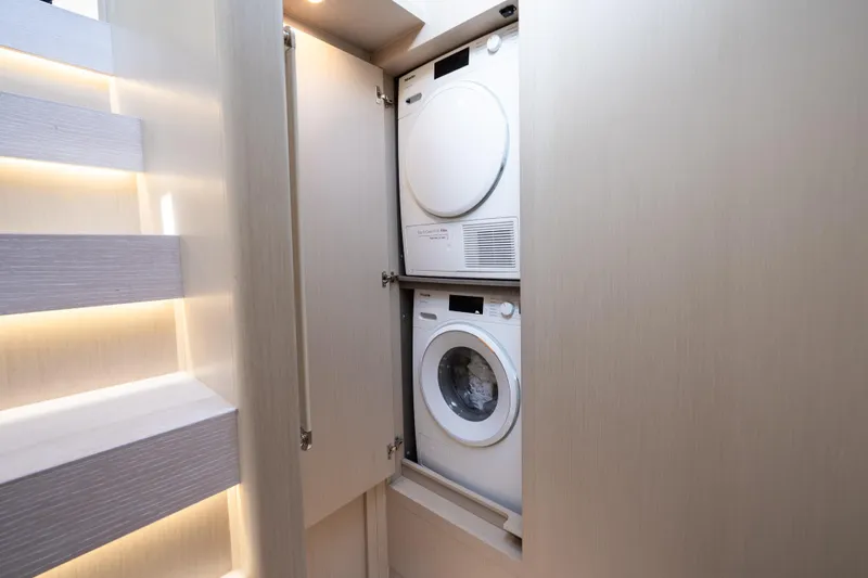 Slide: The Image of Laundry area with stacked washer and dryer in 2024 Azimut Fly 68 yacht. - 36