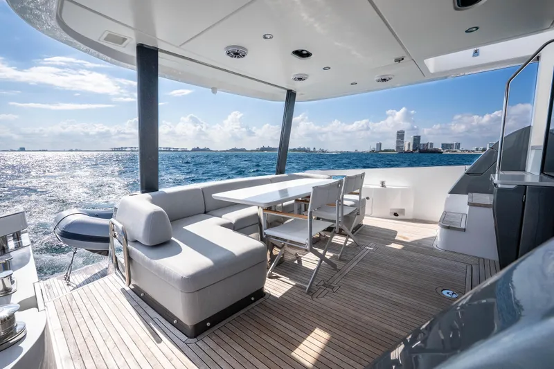 Slide: The Image of Luxurious 2024 Azimut Fly 68 yacht deck with seating, ocean view, and city skyline. - 41