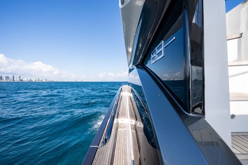Slide: The Image of 2024 Azimut Fly 68 yacht cruising on open blue sea under clear sky. - 43