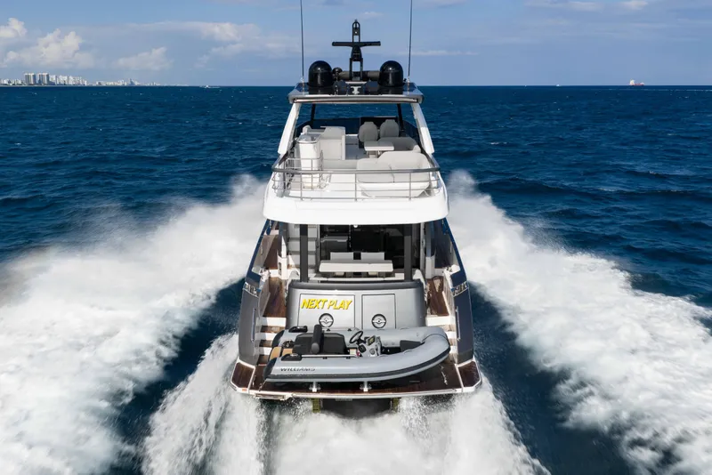 Slide: The Image of 2024 Azimut Fly 68 yacht cruising on open sea, rear view. - 5