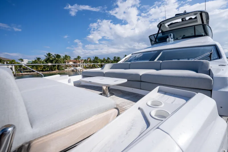 Slide: The Image of 2024 Azimut Fly 68 yacht with luxurious deck seating under a clear blue sky. - 50