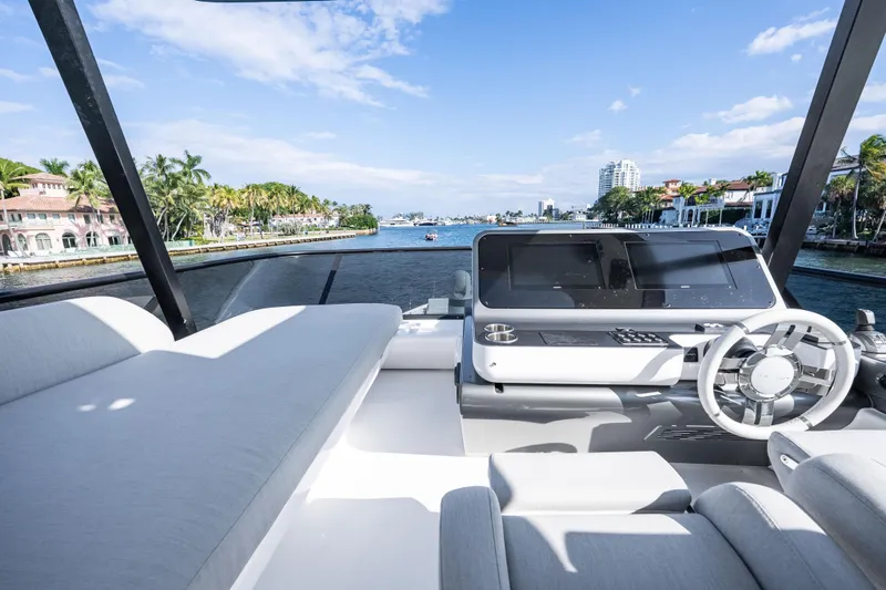 Slide: The Image of 2024 Azimut Fly 68 yacht helm with luxurious seating and waterfront view. - 54
