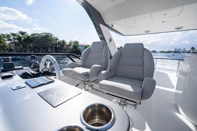 Slide: The Image of 2024 Azimut Fly 68 yacht helm with luxurious seating and modern controls. - 56