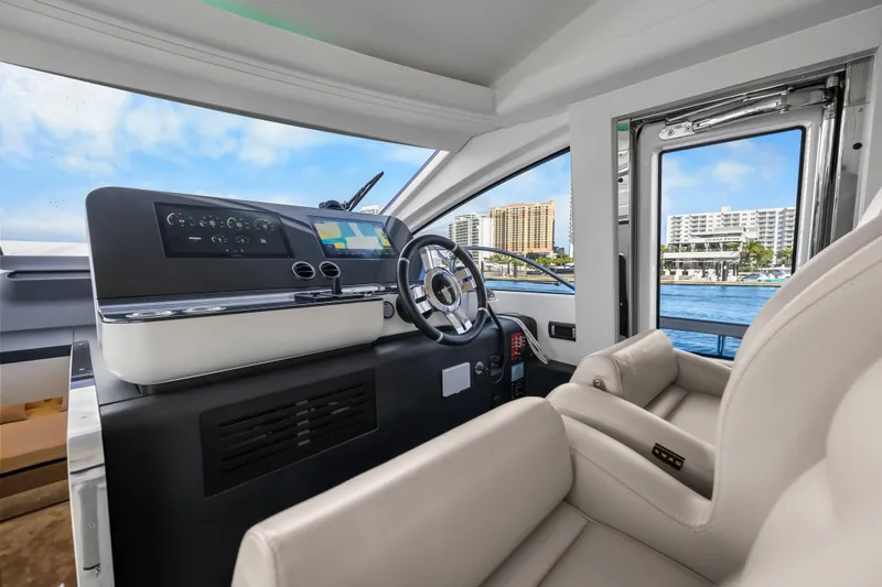 Slide: The Image of 2024 Azimut Fly 68 yacht helm with modern controls and waterfront view. - 64